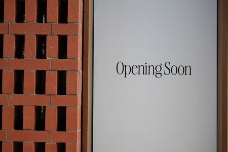 New establishment announcing grand opening in urban areaの写真素材