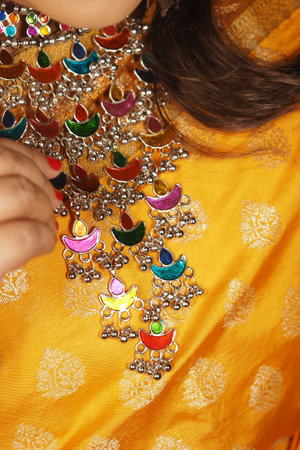 Vibrant jewelry enhances a colorful outfit at a cultural eventの写真素材