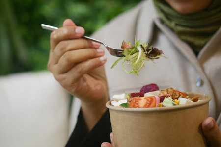 Enjoying a fresh salad in a cozy indoor setting