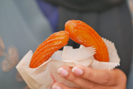Close-Up of Freshly Prepared Glazed Jalebis In Handsの写真素材