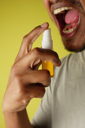 Person using mouth wash sprayの写真素材