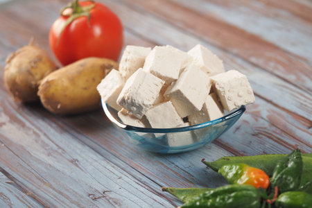 Fresh tofu and vegetables arranged on wooden tableの写真素材