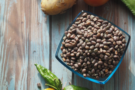 Freshly harvested beans and vegetables on rustic wooden table