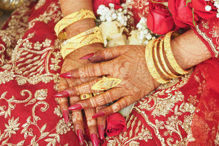 Bridal hands with henna and jewelry at a weddingの写真素材