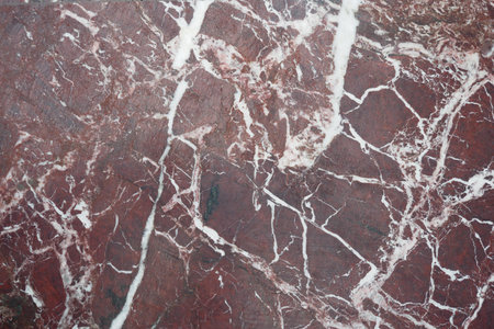 Natural red stone with white veins in detailed texture viewの写真素材