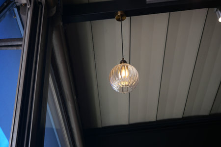 Elegant hanging light fixture illuminates cozy cafe interior