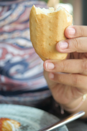 Deliciously crispy bread held in hand during a mealの写真素材