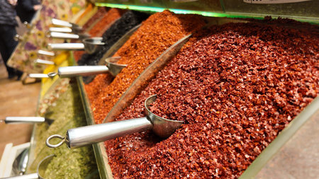 Colorful spices displayed in jars at local market in vibrant settingの写真素材