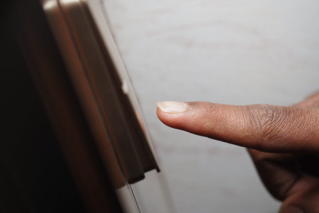 finger pressing the door bell