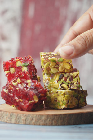 Colorful Turkish delight arranged on a wooden table at a dessert shop