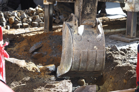 Excavation work in urban area for infrastructure repairsの写真素材