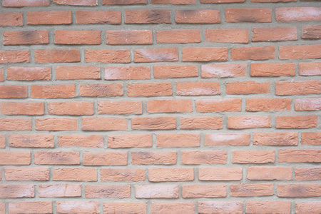 Brick wall with warm tones and textured surfaceの写真素材
