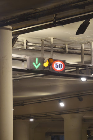 Traffic signals indicating speed limit and lane direction in a tunnelの写真素材