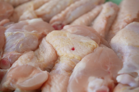 Fresh chicken pieces ready for cooking at a local marketの写真素材