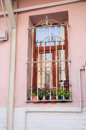 Charming window with vibrant flowers in a rustic buildingの写真素材