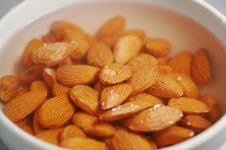 Soaking almonds in water for healthy snacking optionsの写真素材
