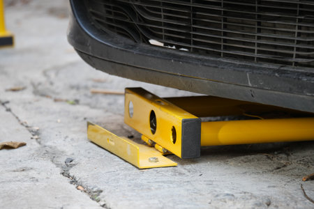 Car immobilizer device used on vehicle in urban parking areaの写真素材