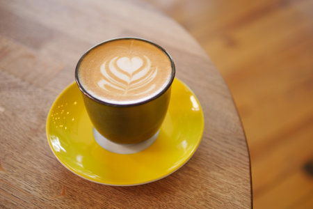 Coffee served in a stylish cup on a wooden tableの写真素材
