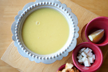 Delicious traditional soup served with toppings and lemon sliceの写真素材