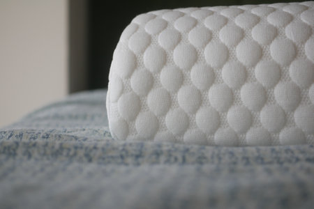 A soft white orthopedic pillow is placed on bed .の写真素材