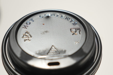 Lid of a hot beverage cup with warning symbols displayed clearly