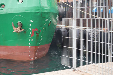 Colorful ship docked at waterfront with visible markingsの写真素材
