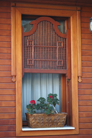 Beautiful wooden window with flower box in charming homeの写真素材