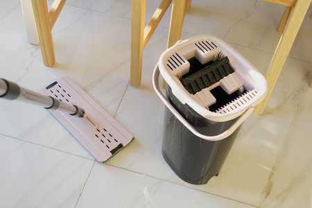Mop and bucket ready for cleaning the tiled floorの写真素材