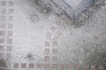 Snowfall covers the ground in a residential area during winter seasonの写真素材