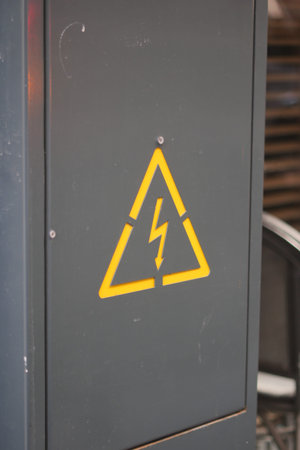 Warning sign indicating electrical hazard near machinery
