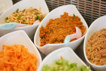 Colorful array of salads and side dishes at a buffet tableの写真素材