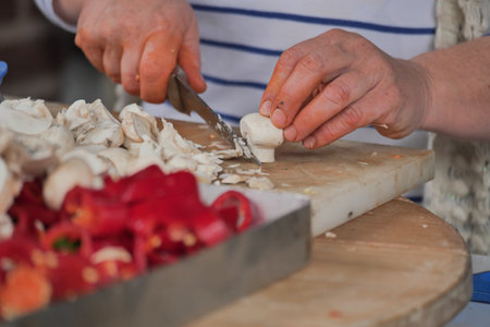 Preparing fresh vegetables for a meal in a cozy kitchenの写真素材