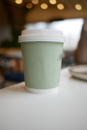 Warm beverage in a minimalist cup at a cozy cafe in the morningの写真素材