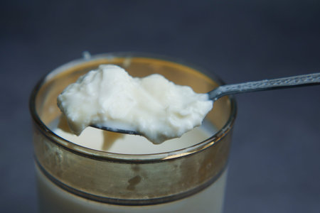 Creamy yogurt served in a glass with a spoon for tasting