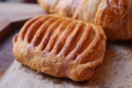 Freshly baked pastry on display in a cozy bakery settingの写真素材