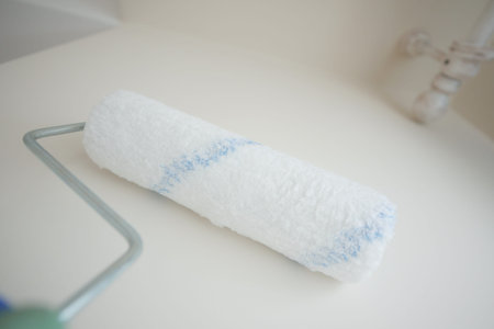 Paint roller resting on a clean surface after a fresh coat application