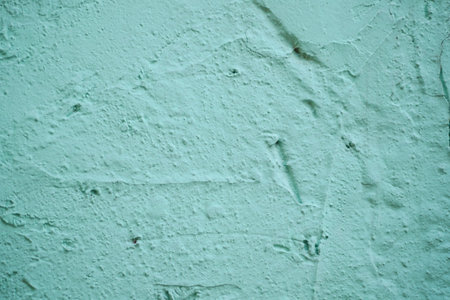 Textured wall with soft green hue creating a calming atmosphereの写真素材