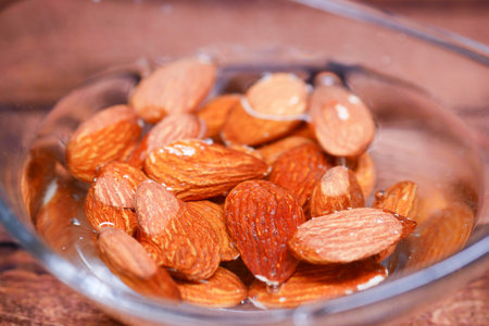 Almonds soaking in water for optimal preparation and health benefitsの写真素材