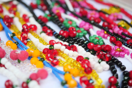 Colorful bead necklaces displayed at a local market in summer sunlight