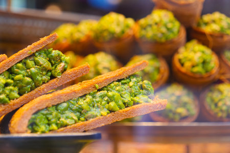 Delicacies filled with pistachio in a bustling marketの写真素材