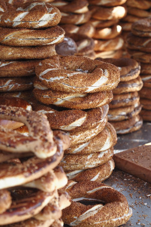 turkish simit stacked in a busy market in the afternoon