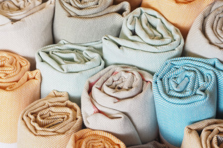 Elegant fabric rolls in soft colors create a charming display