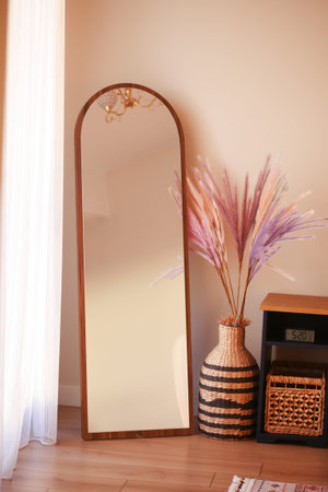 Decorative mirror and colorful plant arrangement in modern interiorの写真素材