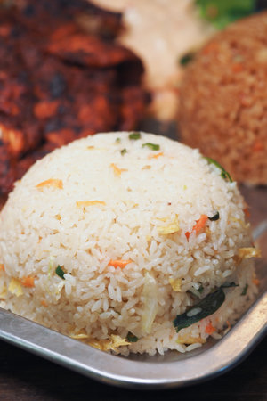 Fluffy rice served with grilled chicken and vegetable dishの写真素材