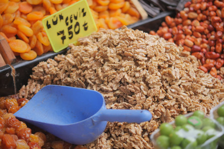 Pile of walnuts at a vibrant market filled with dried fruitsの写真素材