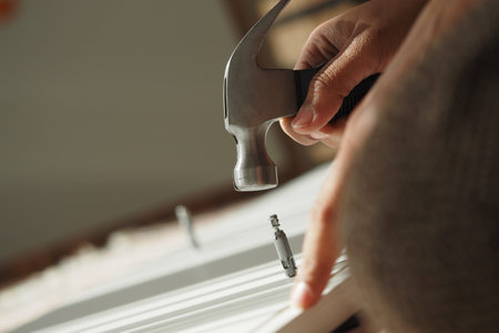 Hammering a nail into wood during a home improvement project