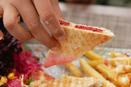 Enjoying a delicious grilled sandwich with fries at a local