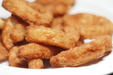 Crunchy fried snacks served on a white plate for a tasty treatの写真素材