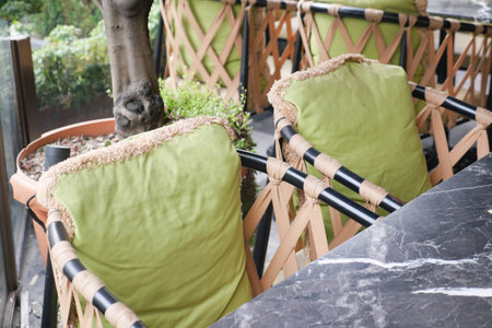 Cozy outdoor seating with green cushions at a stylish cafe