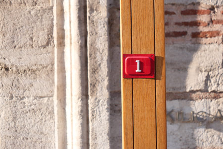Number one marker on wooden post in urban setting during daylight
